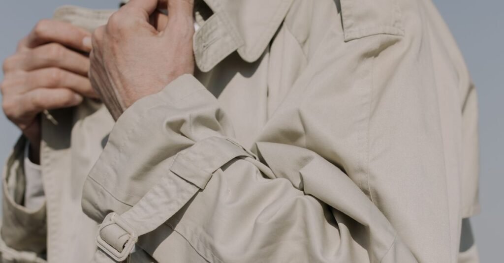 Woman wearing a cropped beige trench coat with jeans
