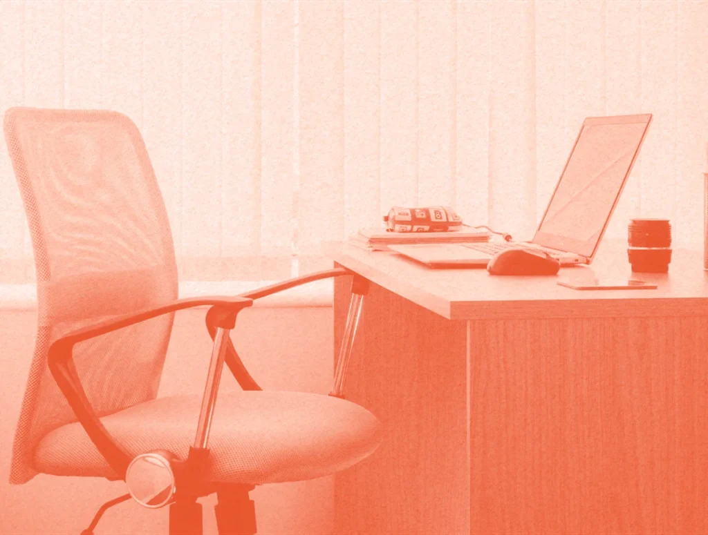Warm-toned minimalist office workspace with laptop on desk