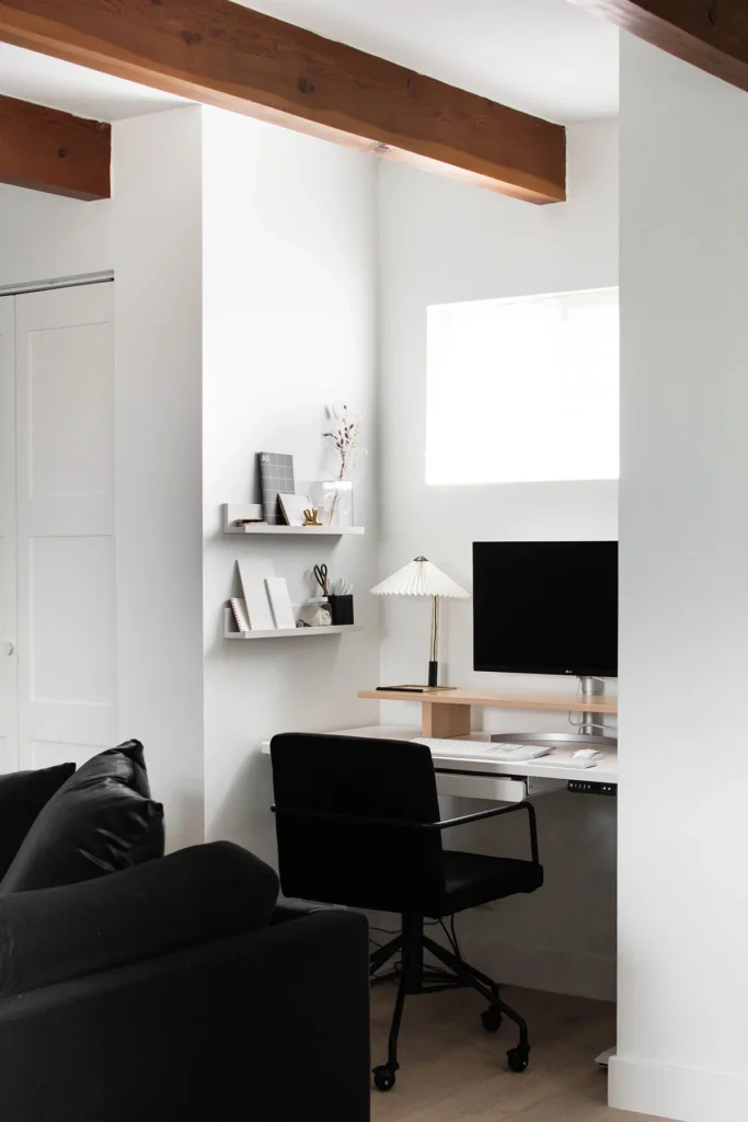 Cozy family room workspace nook with desk and wall shelves