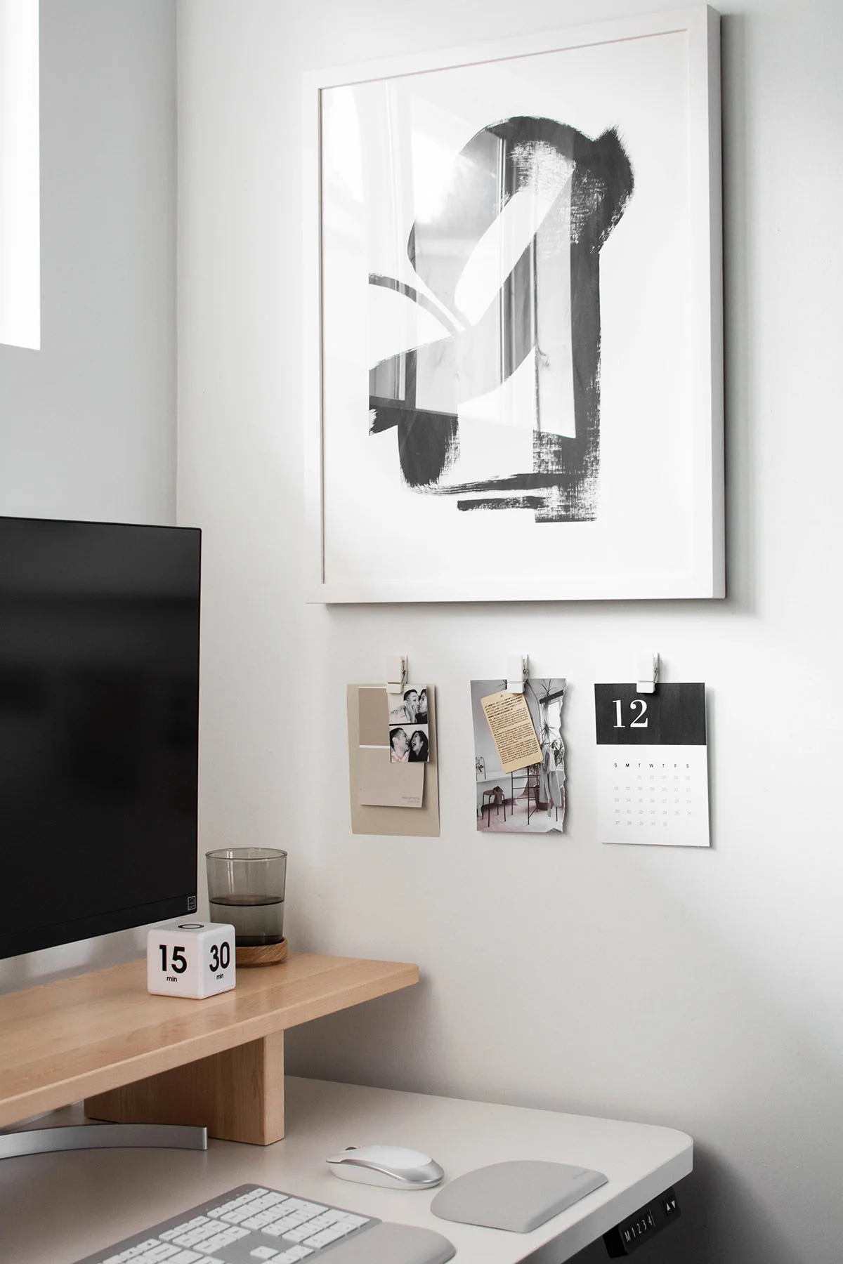 Workspace desk closeup with abstract art and wall clips