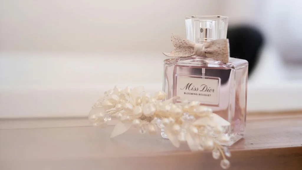 Close-up of layered perfume bottles on a vanity table