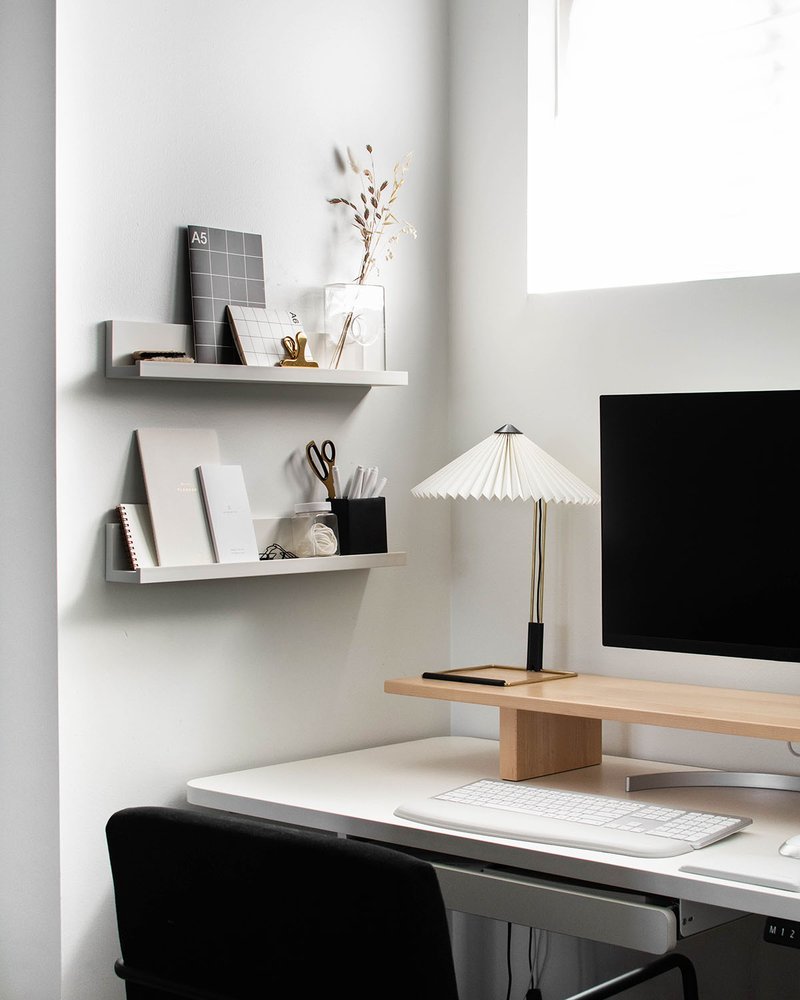 Clean workspace corner with adjustable standing desk setup