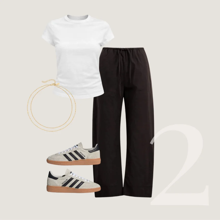 White tee, black trousers, gold necklace, and sneakers outfit