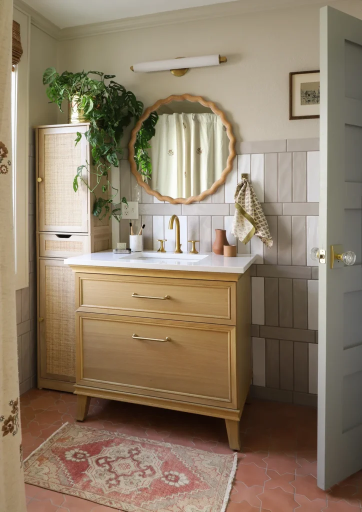 Renovated bathroom with patterned subway tile and brass vanity