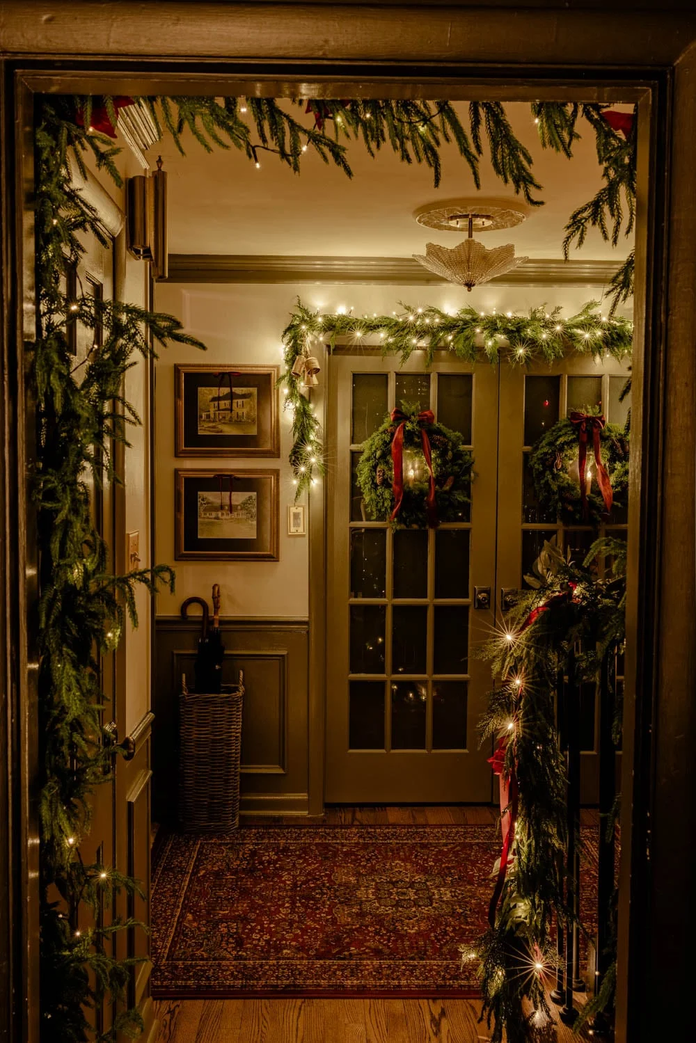 Entryway doorway decorated with garland and soft string lights
