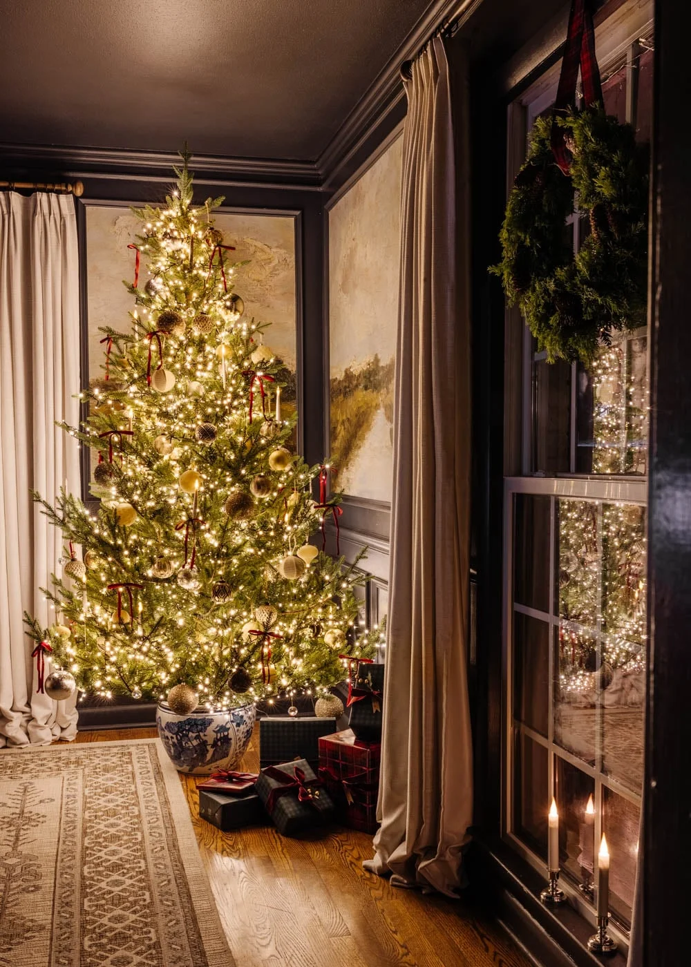 Dining room Christmas tree glowing in deep green and amber light