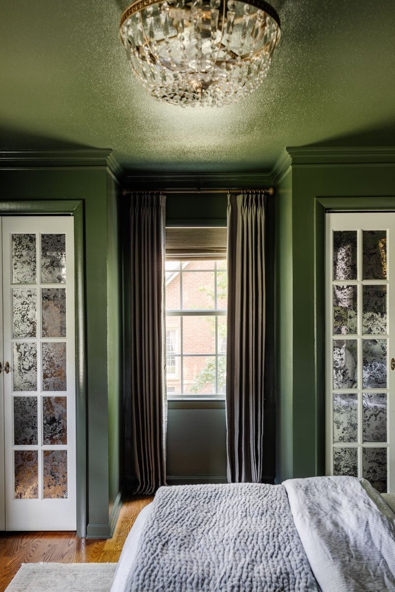 Green curtains in a bright bedroom with soft light